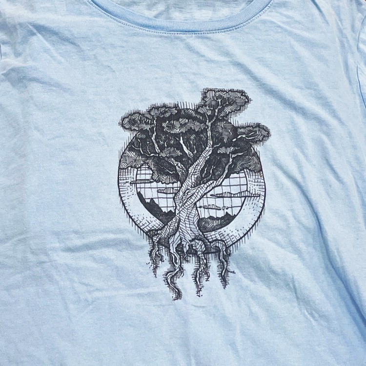 Photo of a blue t-shirt with a pen illustration of Yggdrasil, "the World Tree," on it.