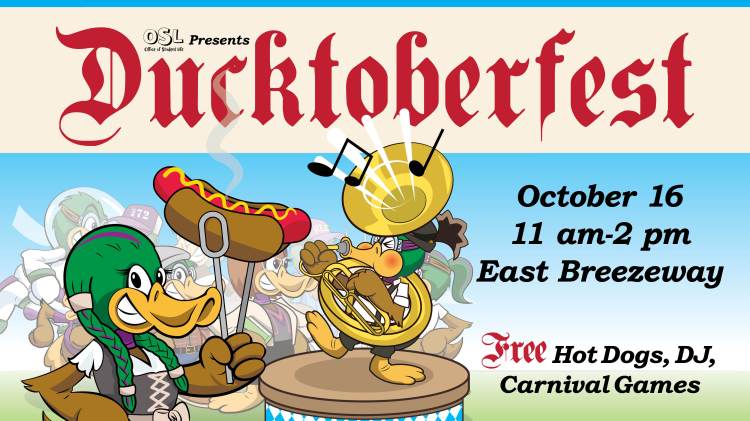 A digital display with illustrations of anthropomorphic ducks in German attire, one playing a sousaphone and one holding a bratwurst in a bun with tongs. In the background are eight other anthropomorphic ducks in various outfits watching. The text reads "OSL Office of Student Life Presents: Ducktoberfest, October 16 | 11 am–2 pm | East Breezeway. Free Hot Dots, DJ, Carnival Games."